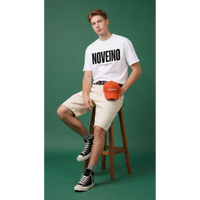 NOVEINO House Standard T-shirt in neutral color, casual fit, with minimalist house graphic on front, made from soft cotton fabric.