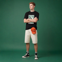 NOVEINO t-shirt with postage stamp graphic, casual fit, soft fabric, and short sleeves, displayed on a white background.